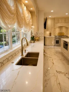 a kitchen with stainless steel appliances granite countertop a sink and a stove