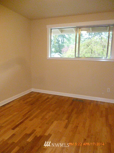 101 234th Place Southeast Bothell, WA 98021 - Photo 16 of 23 a view of an empty room with wooden floor and a window