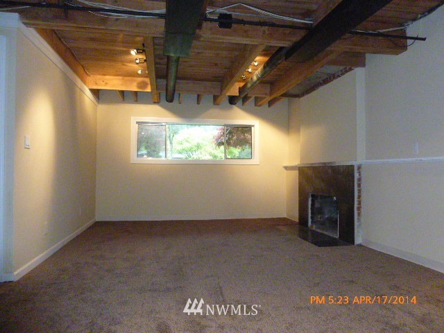 101 234th Place Southeast Bothell, WA 98021 - Photo 17 of 23 a view of empty room with wooden floor and fireplace