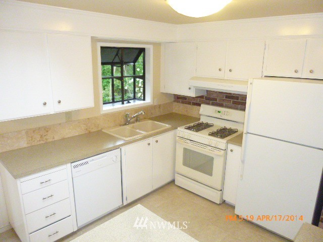101 234th Place Southeast Bothell, WA 98021 - Photo 8 of 23 a view of a kitchen with white cabinets and a sink