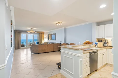 a view of kitchen with stainless steel appliances granite countertop a sink and cabinets