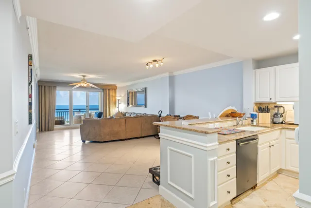 a view of kitchen with stainless steel appliances granite countertop a sink and cabinets
