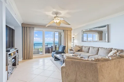 a living room with furniture and large windows