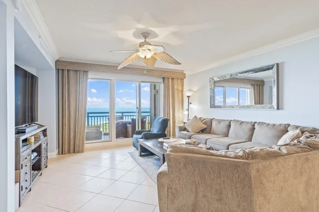a living room with furniture and large windows