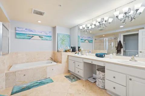 a bathroom with a tub sink and mirror