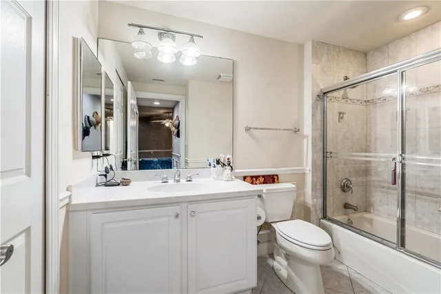 a bathroom with a sink toilet vanity and shower
