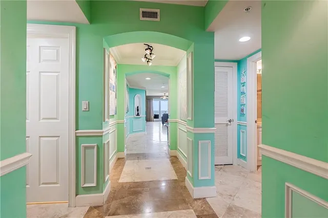 a view of a hallway with a livingroom and furniture