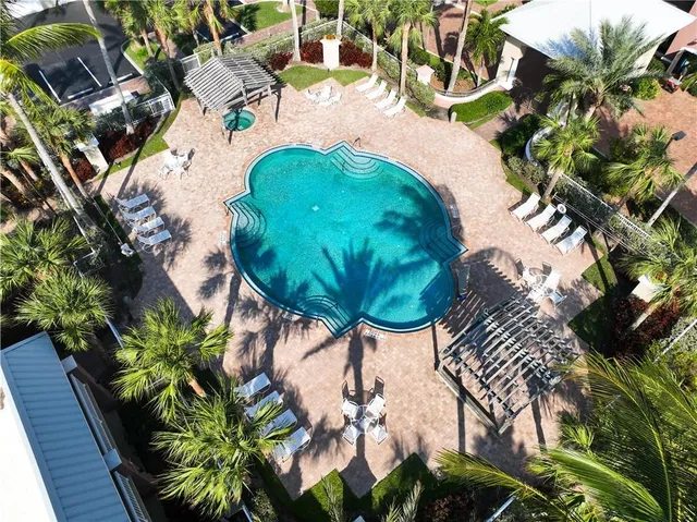 a view of a swimming pool with a yard and sitting area