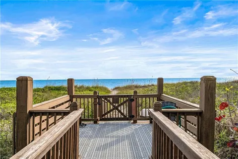 a view of a balcony with wooden floor and roof with city view