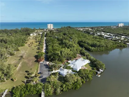 an aerial view of a houses with a lake view