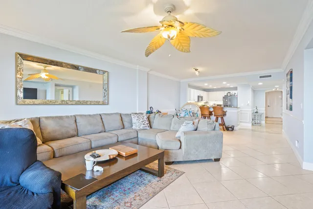 a living room with furniture a table and a chandelier