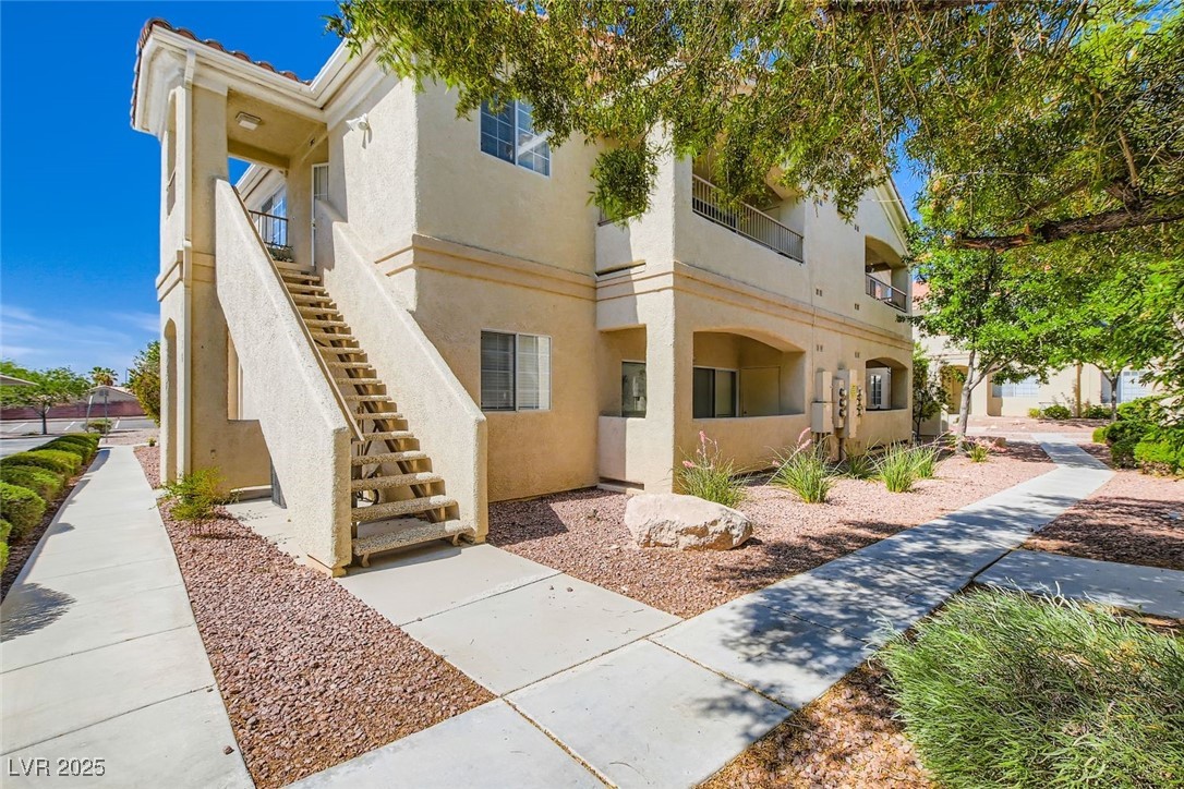 View of property with stairs