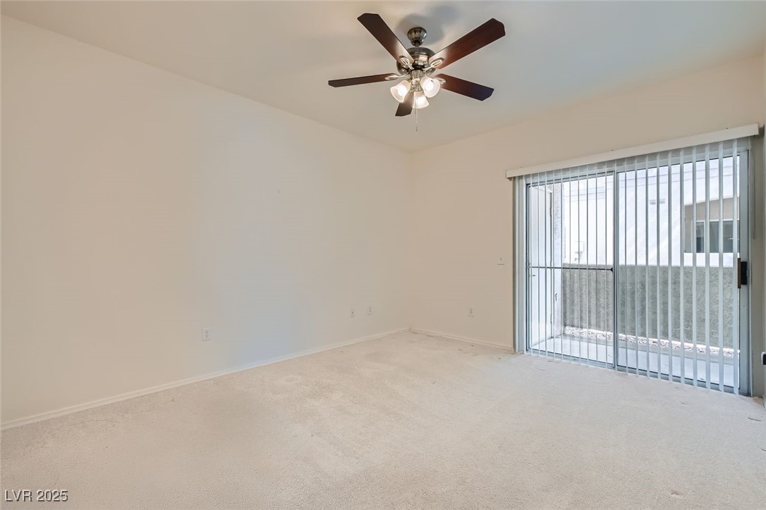 1881 West Alexander Road, Unit 1092 North Las Vegas, NV 89032 - Photo 4 of 11 Spare room featuring carpet and a ceiling fan
