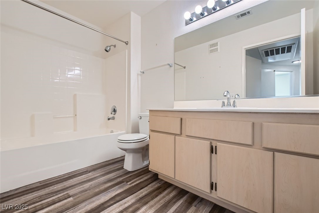 1881 West Alexander Road, Unit 1092 North Las Vegas, NV 89032 - Photo 7 of 11 Full bathroom with shower / washtub combination, dark wood-style floors, and vanity