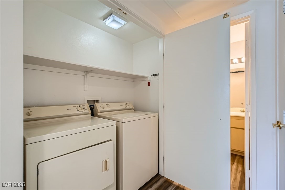 1881 West Alexander Road, Unit 1092 North Las Vegas, NV 89032 - Photo 8 of 11 Laundry area with dark wood finished floors and washing machine and dryer