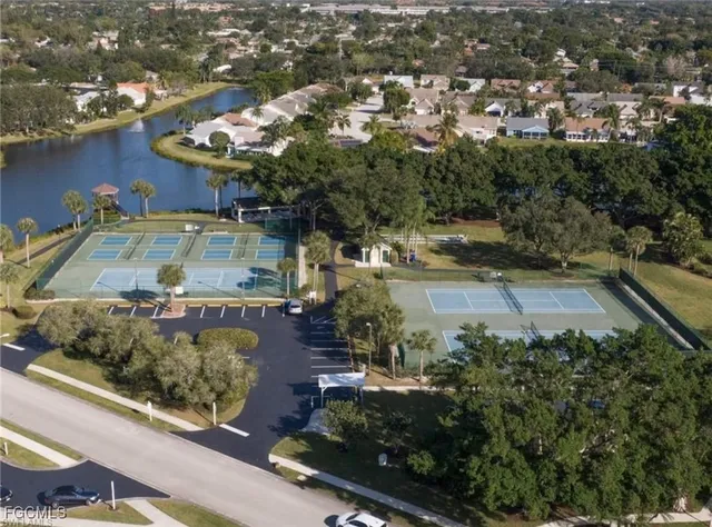 an aerial view of a house with a yard lake view and mountain view