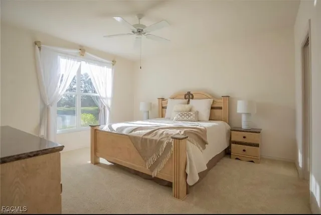 a spacious bedroom with a bed and a large window