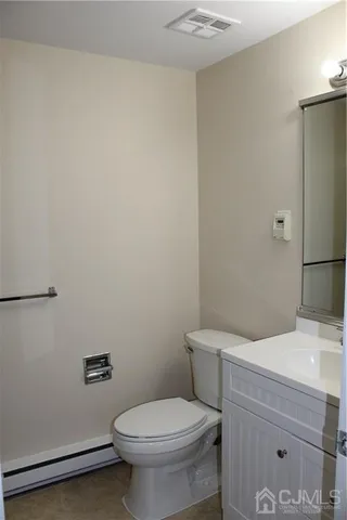 a white toilet sitting next to a bathroom sink
