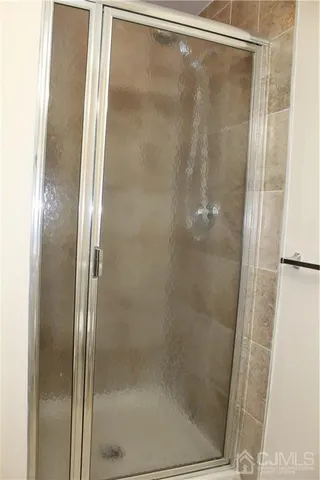 a bathroom with a glass shower door