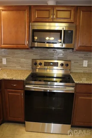 a stove top oven sitting inside of a kitchen