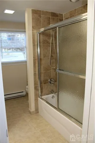 a bathroom with a glass shower door