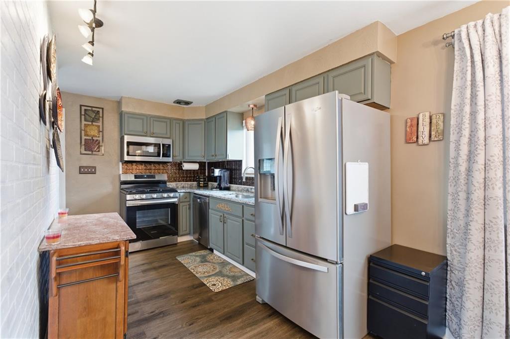 1630 Old Brodhead Road Monaca, PA 15061 - Photo 6 of 28 a kitchen with stainless steel appliances a refrigerator a stove a sink and a refrigerator
