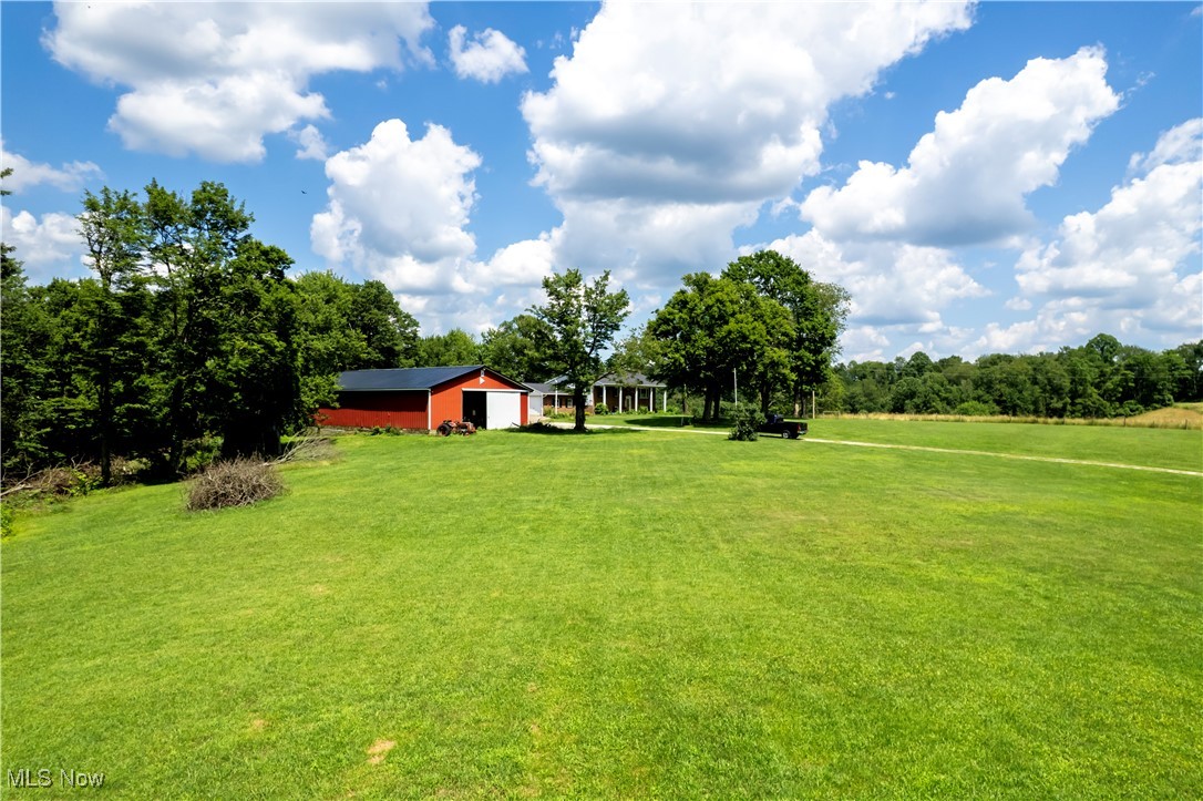 1292 Cinder Road Southeast Carrollton, OH 44615 - Photo 13 of 42 View of grassy yard with a pole building, an outbuilding, and a garage