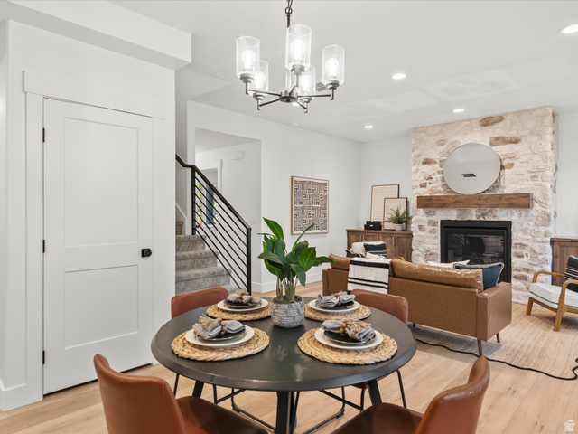 1267 West 2350 South Perry, UT 84302 - Photo 16 of 35 Dining area with a modern chandelier and wood-finish flooring