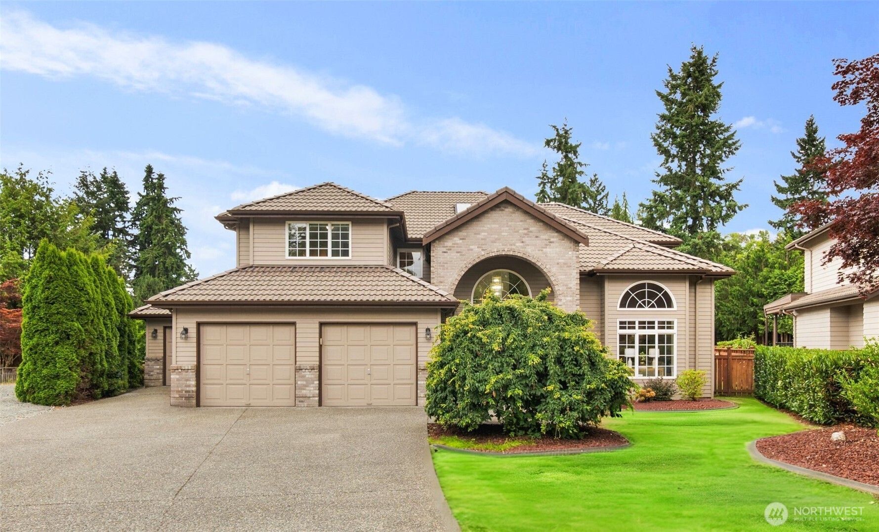 a front view of a house with a garden