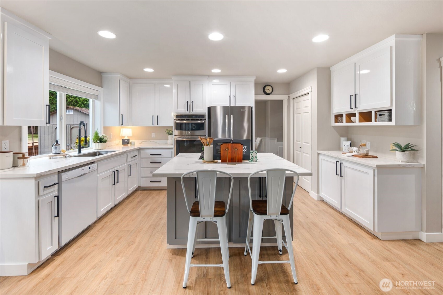 1514 232nd Place Southwest Bothell, WA 98021 - Photo 11 of 38 a kitchen with a table chairs sink microwave and cabinets