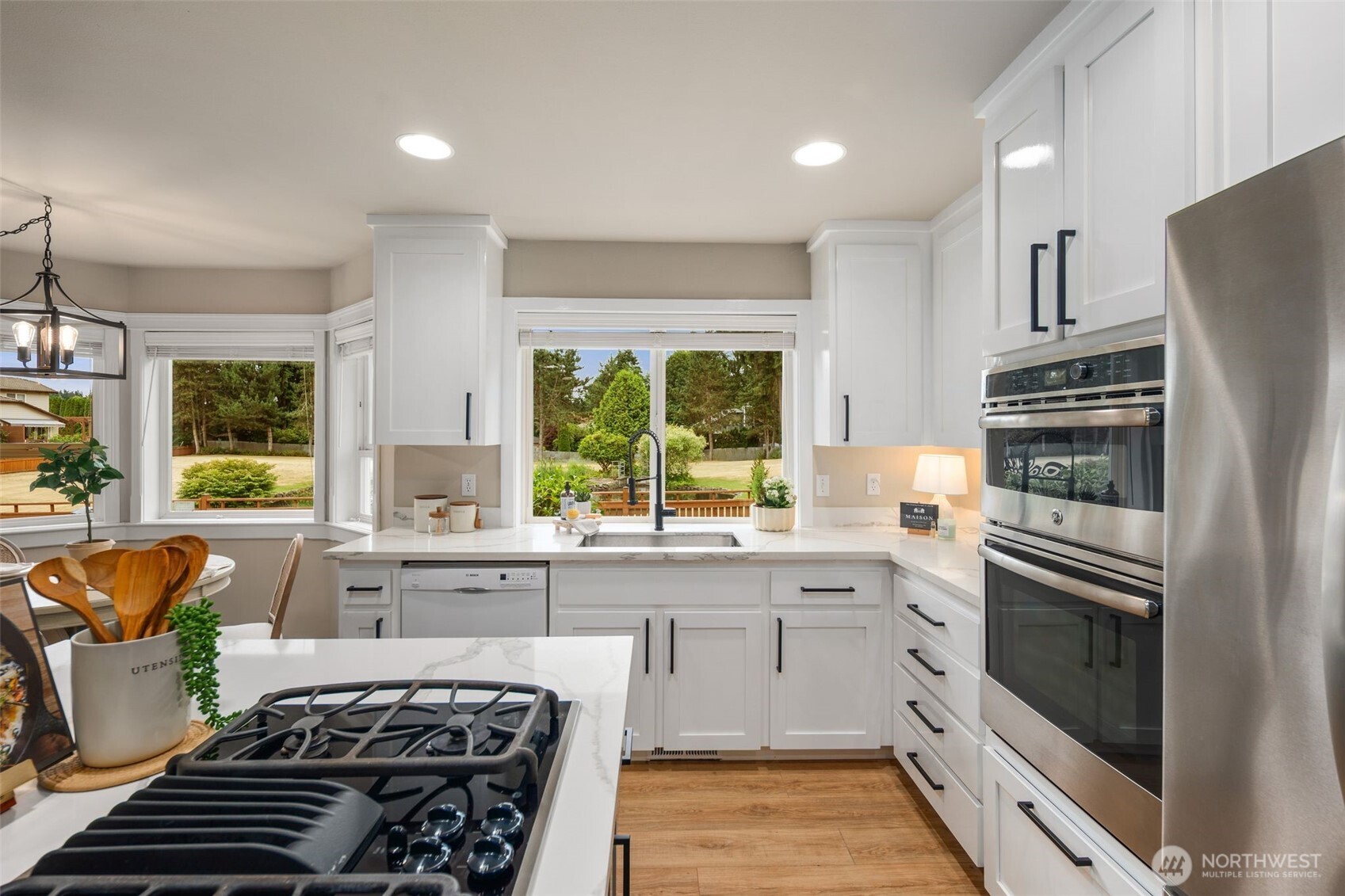 1514 232nd Place Southwest Bothell, WA 98021 - Photo 12 of 38 a kitchen with stainless steel appliances a stove a sink and a refrigerator
