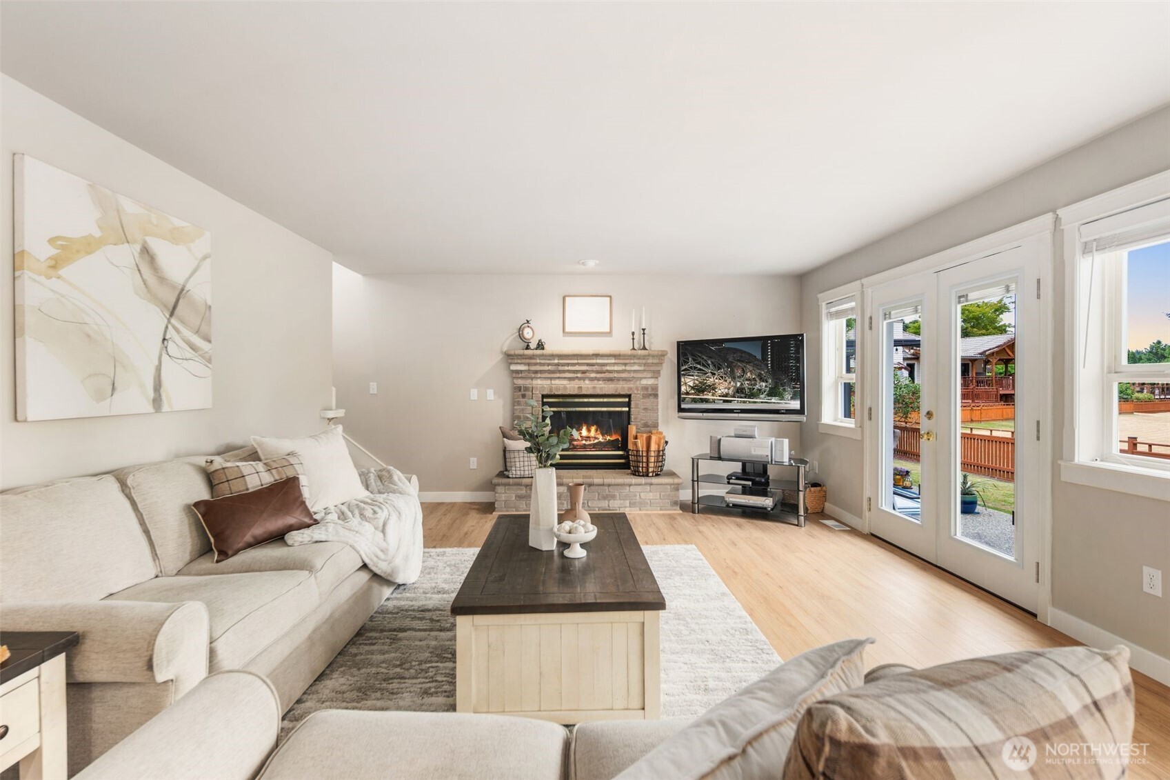 1514 232nd Place Southwest Bothell, WA 98021 - Photo 8 of 38 a living room with furniture a flat screen tv and a fireplace