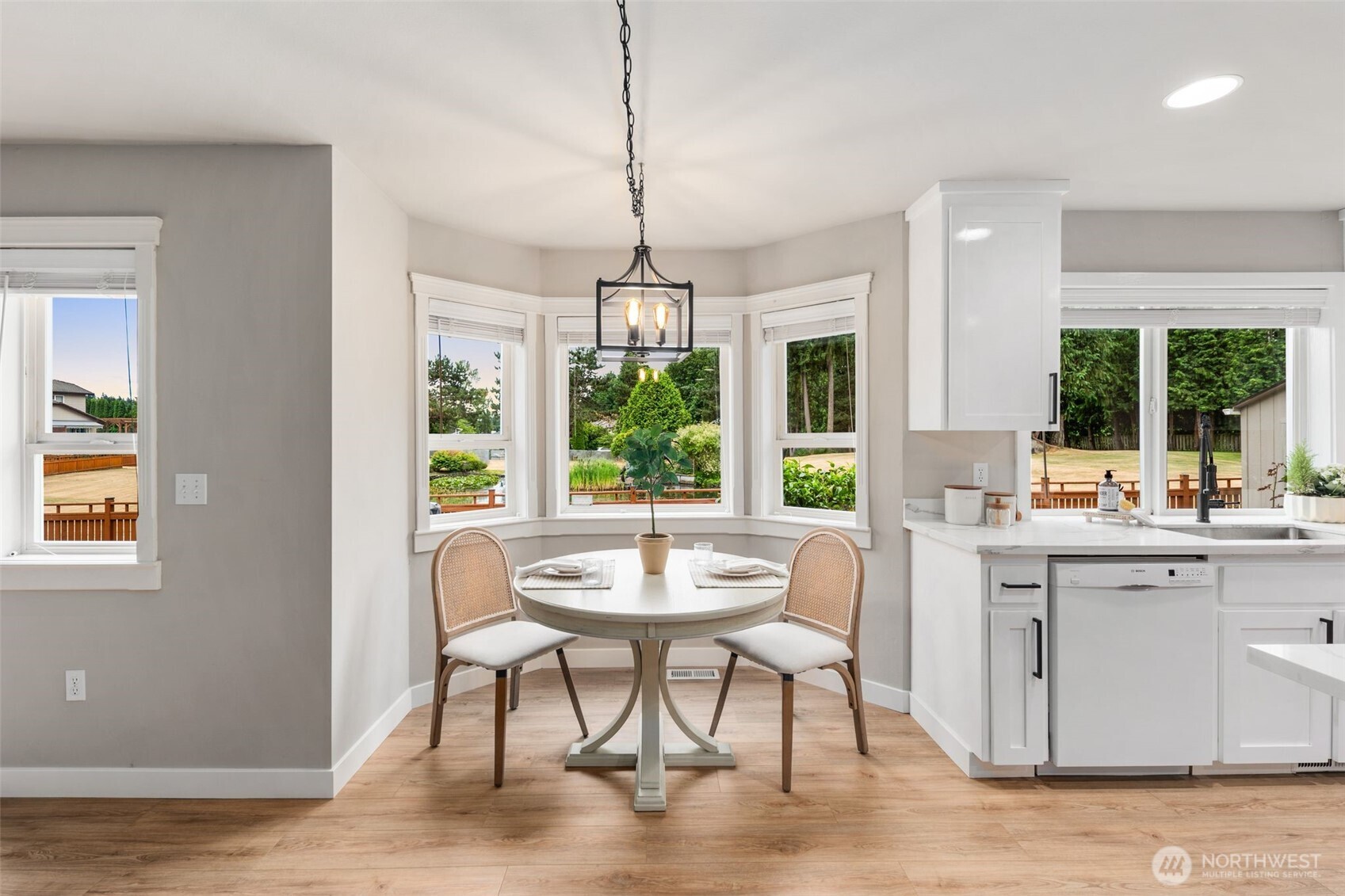 1514 232nd Place Southwest Bothell, WA 98021 - Photo 10 of 38 a dining room with wooden floor a chandelier a wooden table and chairs