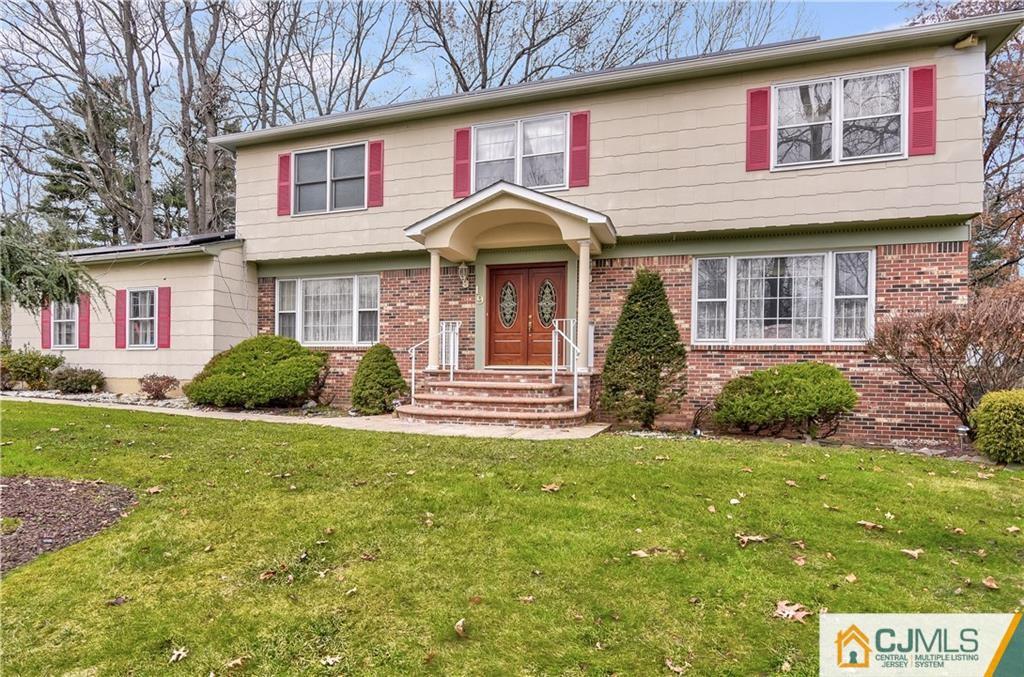 19 Thomas Road East Brunswick, NJ 08816 - Photo 1 of 37 a front view of a house with a yard and garage