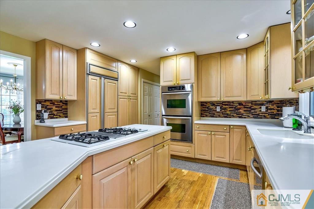 19 Thomas Road East Brunswick, NJ 08816 - Photo 17 of 37 a kitchen with stainless steel appliances kitchen island granite countertop a sink stove and refrigerator