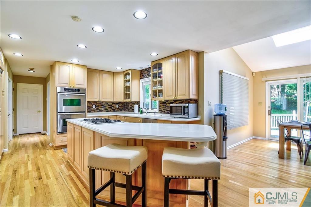 19 Thomas Road East Brunswick, NJ 08816 - Photo 21 of 37 a large kitchen with a table and chairs in it