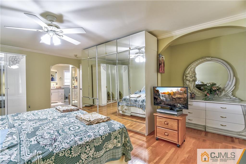 19 Thomas Road East Brunswick, NJ 08816 - Photo 25 of 37 a bedroom with a bed and a flat screen tv