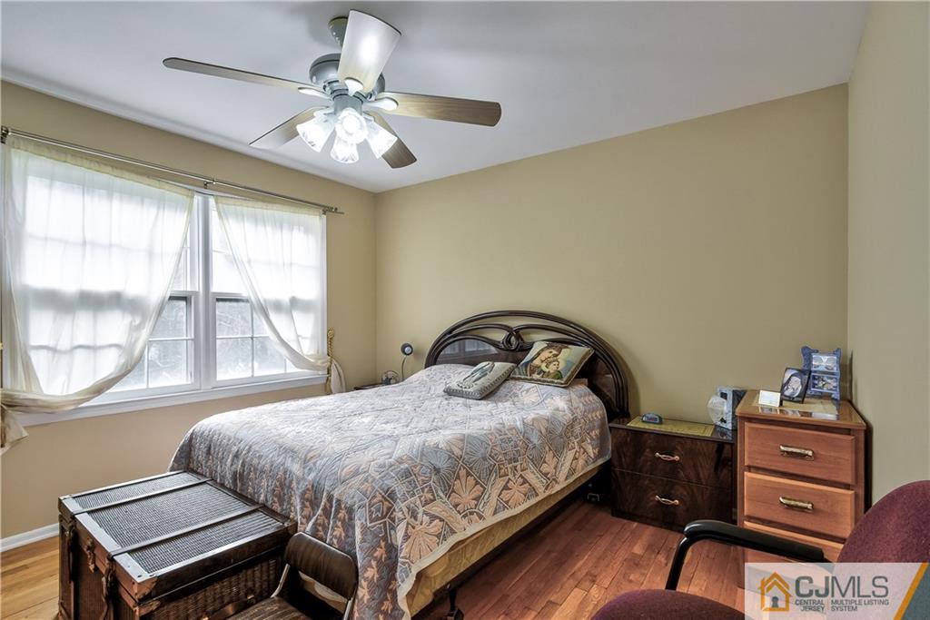 19 Thomas Road East Brunswick, NJ 08816 - Photo 28 of 37 a bedroom with a bed and large windows