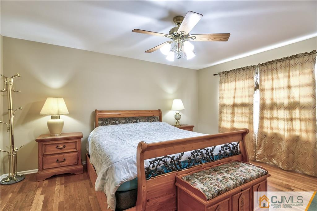 19 Thomas Road East Brunswick, NJ 08816 - Photo 29 of 37 a bedroom with a bed and wooden floor