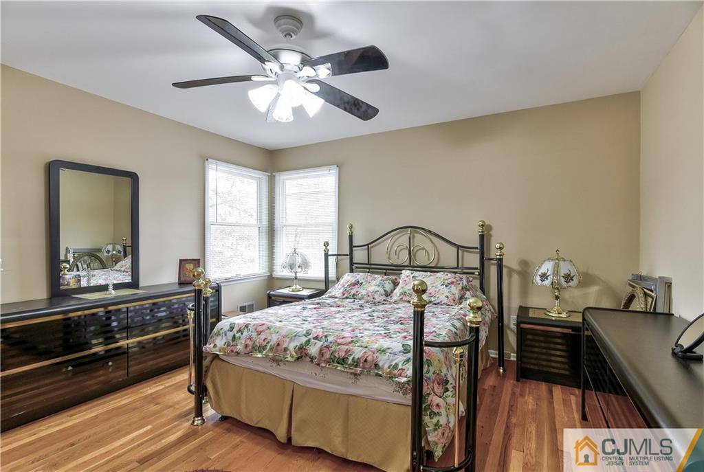 19 Thomas Road East Brunswick, NJ 08816 - Photo 30 of 37 a bedroom with a bed and a large mirror on the dresser