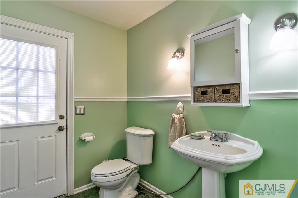 19 Thomas Road East Brunswick, NJ 08816 - Photo 32 of 37 a bathroom with a toilet sink and mirror