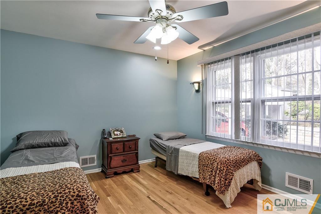 19 Thomas Road East Brunswick, NJ 08816 - Photo 33 of 37 a bedroom with a bed and a chandelier