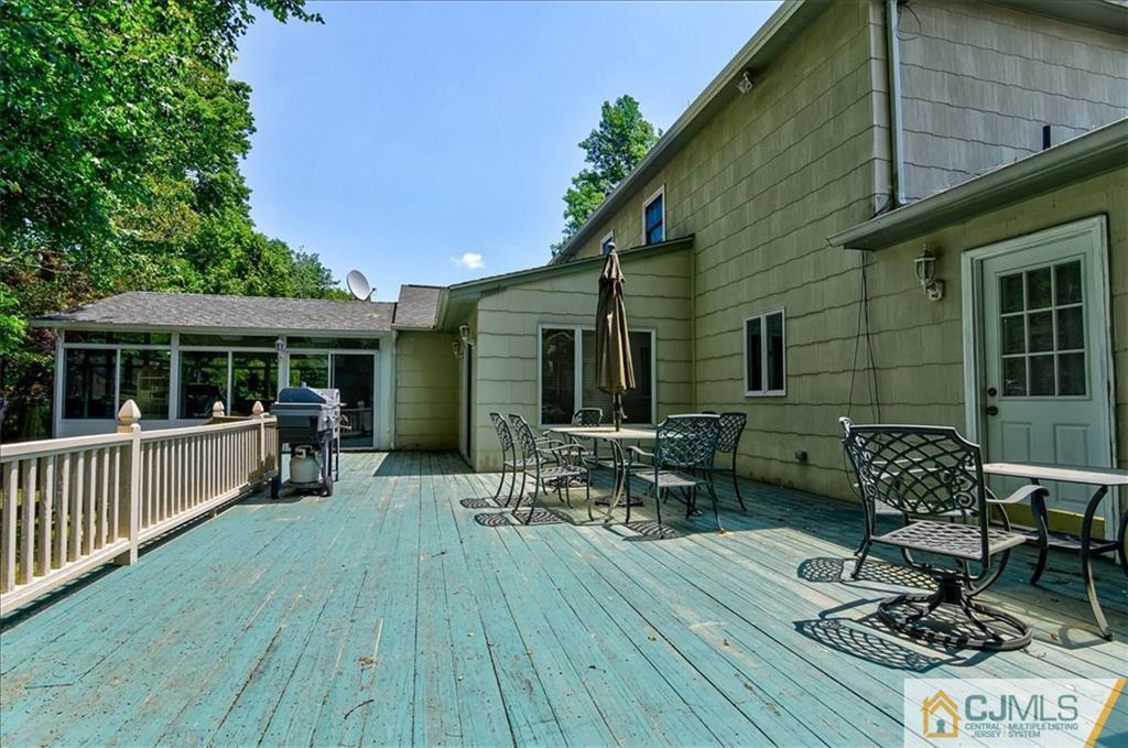 19 Thomas Road East Brunswick, NJ 08816 - Photo 34 of 37 a view of house with deck outdoor seating and green space