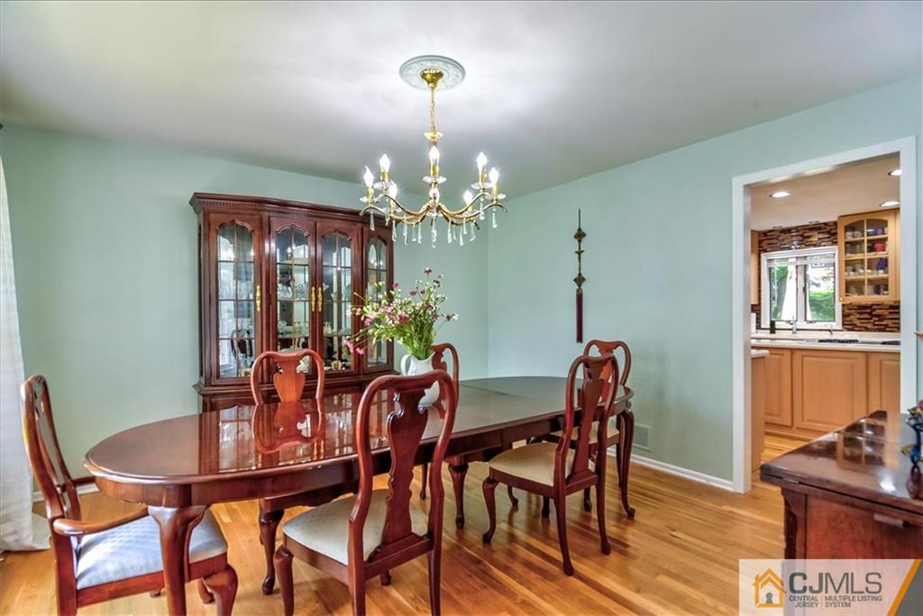19 Thomas Road East Brunswick, NJ 08816 - Photo 7 of 37 a view of a dining room with furniture and chandelier