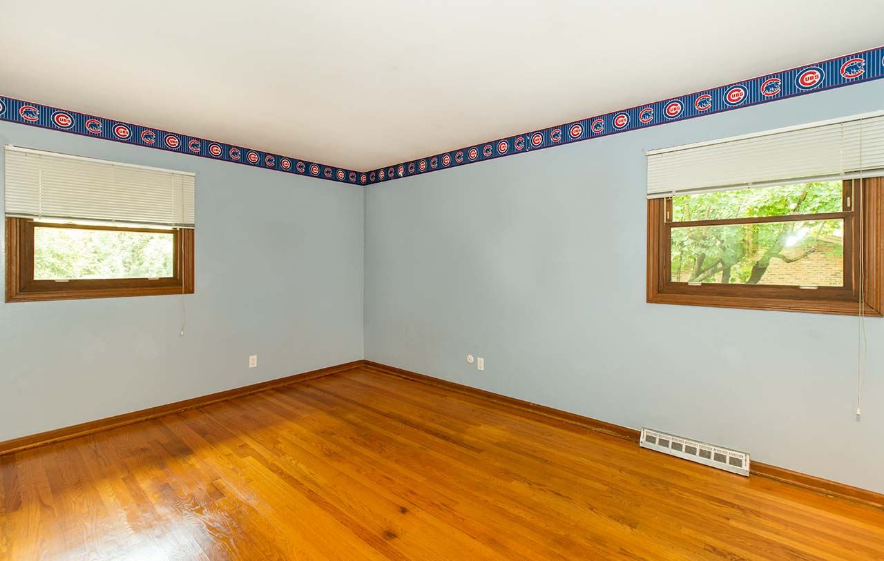 5221 Brookview Road Rockford, IL 61107 - Photo 14 of 25 a view of a room with wooden floor and windows