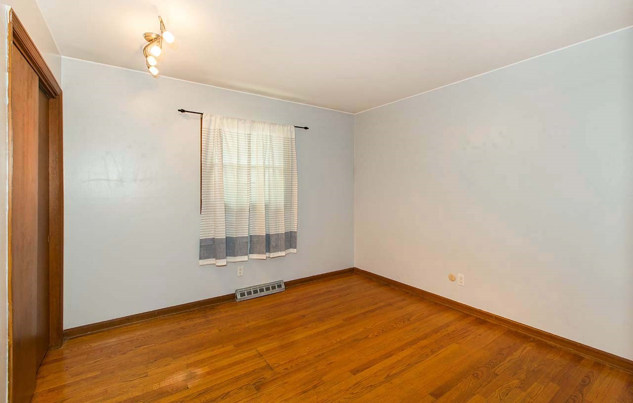 5221 Brookview Road Rockford, IL 61107 - Photo 15 of 25 a view of an empty room with wooden floor and a window