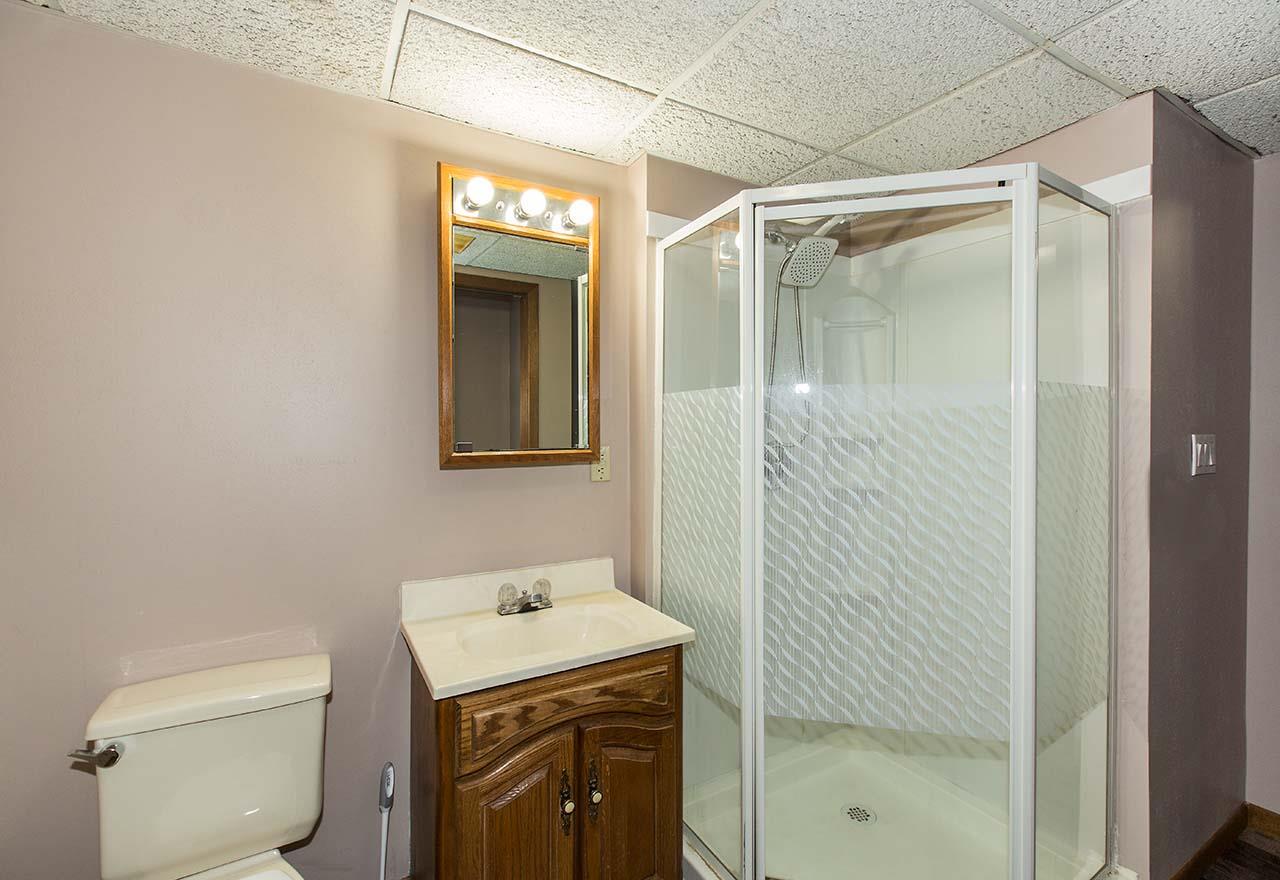 5221 Brookview Road Rockford, IL 61107 - Photo 17 of 25 a bathroom with a shower a toilet and a sink