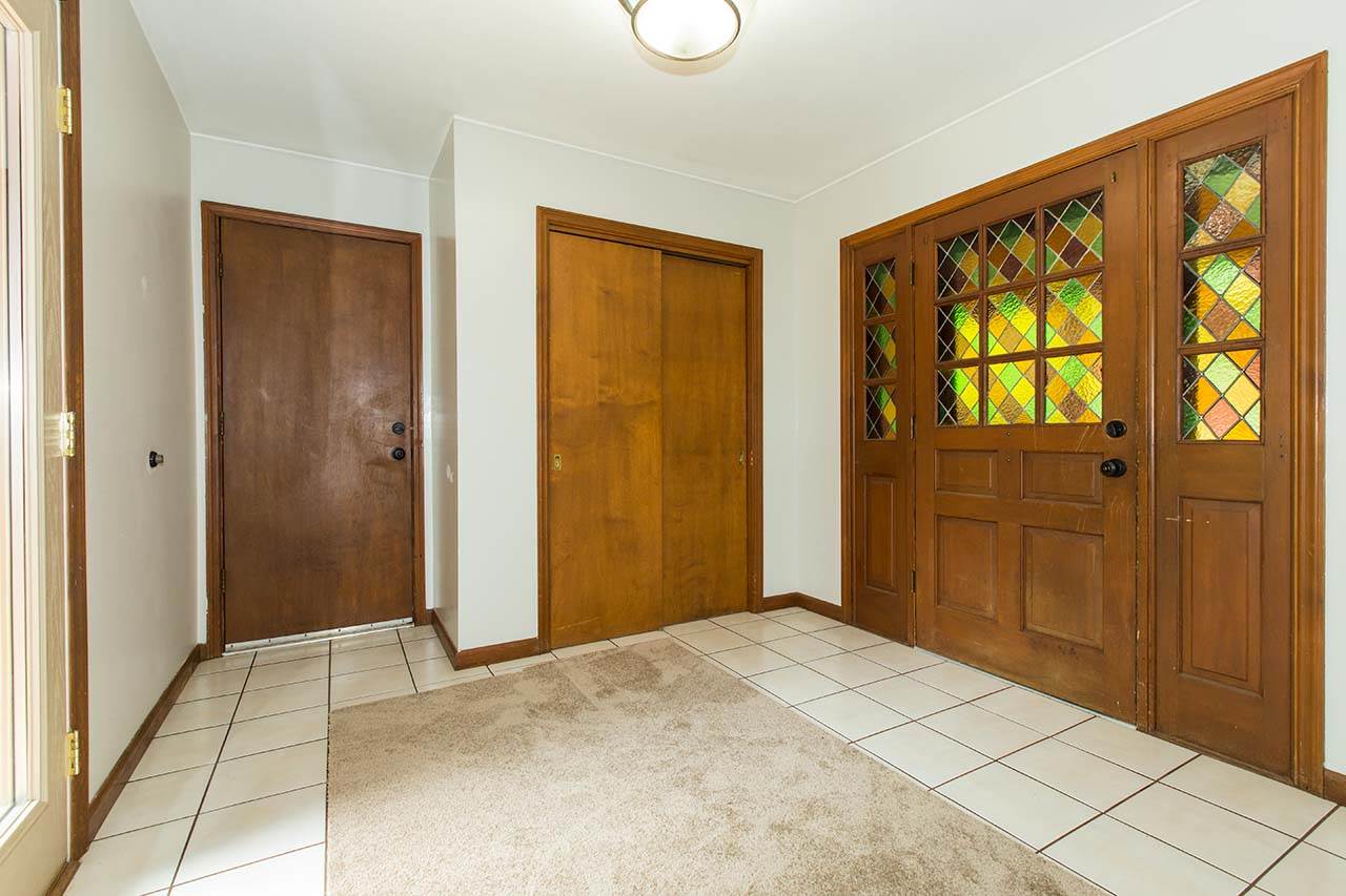 5221 Brookview Road Rockford, IL 61107 - Photo 3 of 25 a view of an empty room with wooden floor and windows