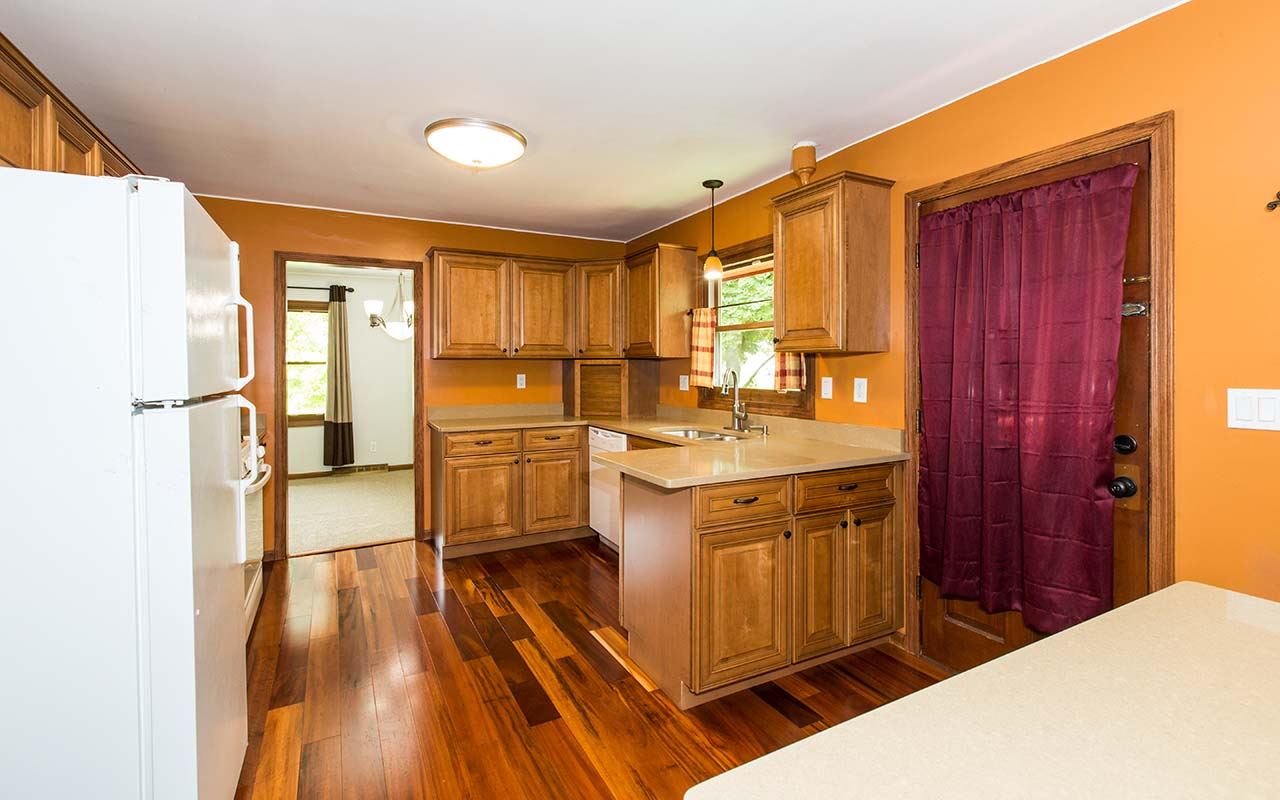 5221 Brookview Road Rockford, IL 61107 - Photo 7 of 25 a kitchen with a sink and wooden floor