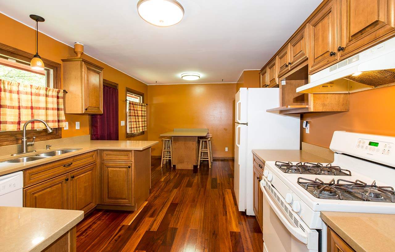 5221 Brookview Road Rockford, IL 61107 - Photo 8 of 25 a kitchen with a stove a sink and wooden floor